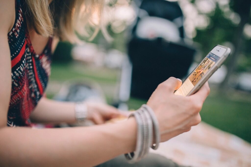 Person reading a social media feed on a phone